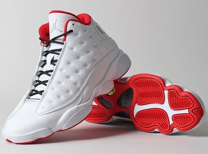 Nike's "Air Jordan 13 Retro" sneakers in the classic "He Got Game" colorway, distinguished by their clean white and black leather upper with vibrant red accents