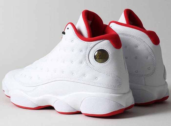 Nike's "Air Jordan 13 Retro" sneakers in the classic "He Got Game" colorway, distinguished by their clean white and black leather upper with vibrant red accents