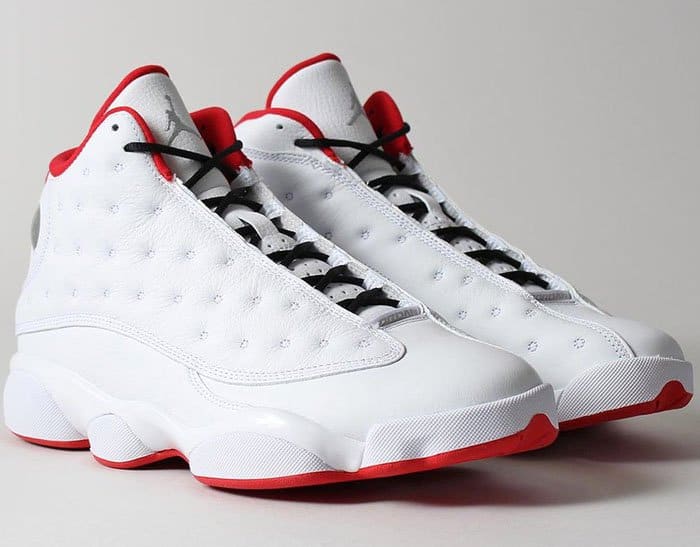 Nike's "Air Jordan 13 Retro" sneakers in the classic "He Got Game" colorway, distinguished by their clean white and black leather upper with vibrant red accents
