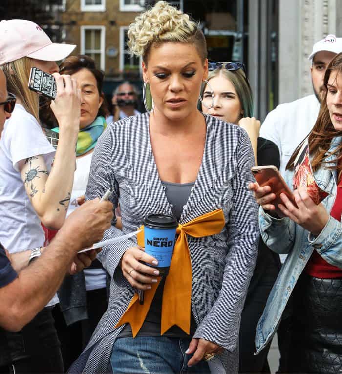 Fans gathered around as Pink greeted them in London, coffee in hand and smile intact