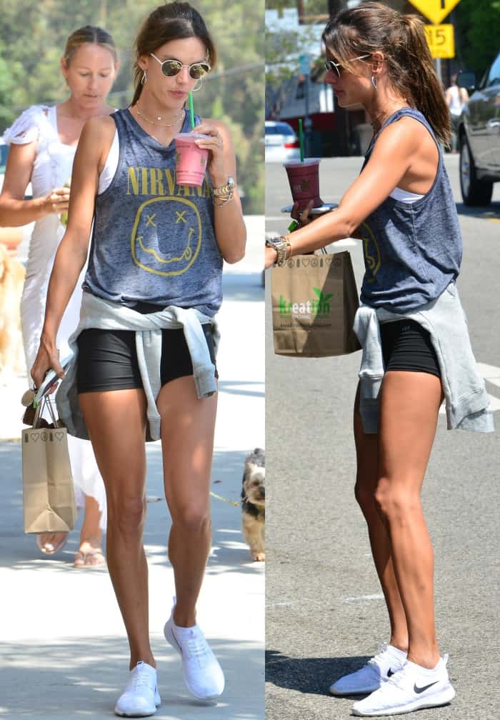 Alessandra Ambrosio styling a faded Nirvana tank and bike shorts with crisp white Nike "Juvenate" sneakers for an effortless off-duty look