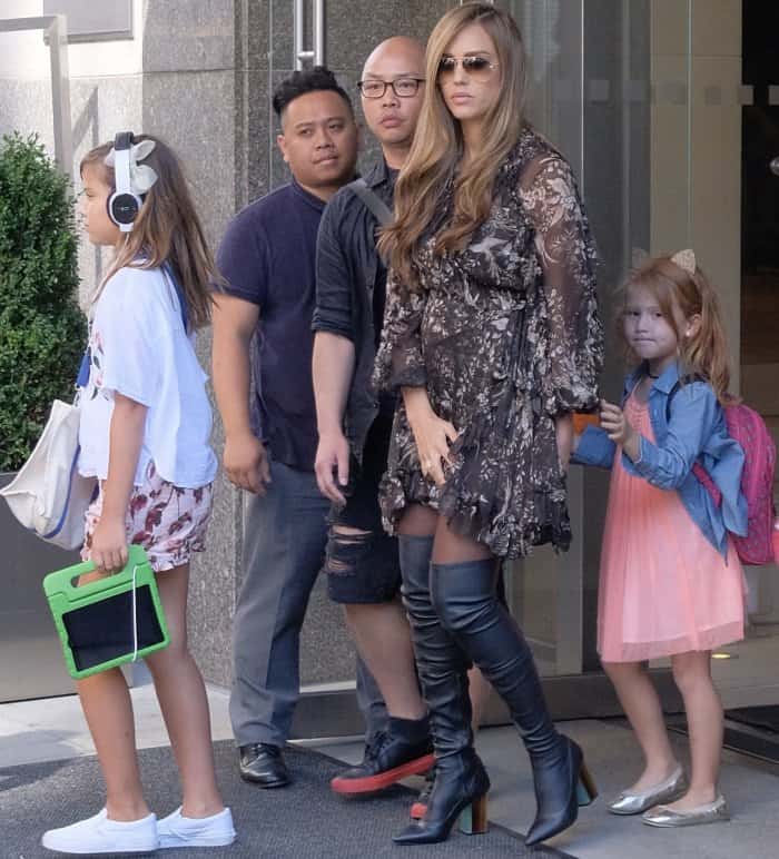 Honor Marie wears a white top with floral shorts and sneakers, holding a green tablet, while Haven Garner looks cute in a peach dress with a denim jacket and cat-ear headband