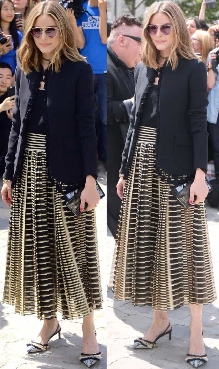 Olivia Palermo wearing a black tassel jacket, a black top, a yellow skirt with geometric stripes, and fringe-embellished slingback shoes at the Christian Dior Fall/Winter 2017 show during Paris Haute Couture Fashion Week