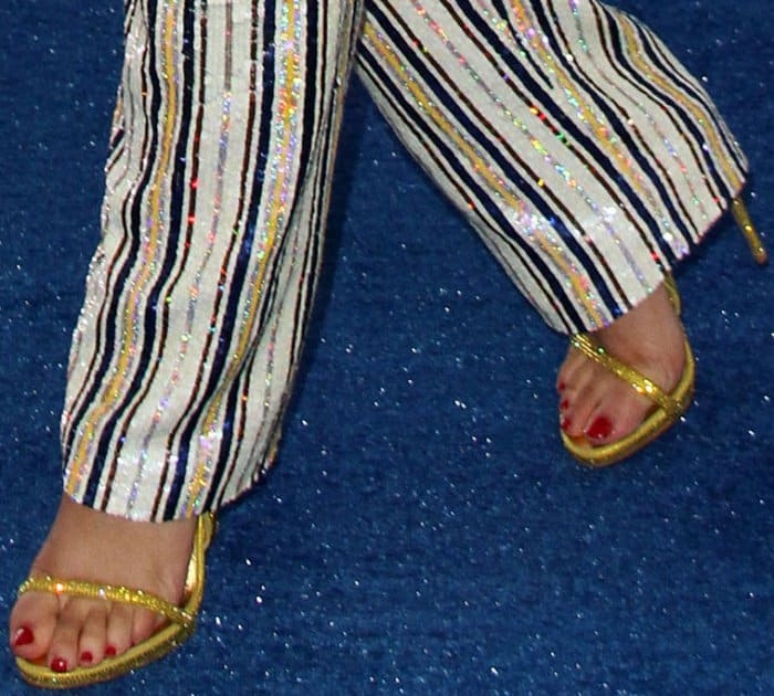 Zendaya’s gold Le Silla sandals offered a glamorous contrast to her red pedicure, peeking out from beneath her sequin-striped Ashish trousers