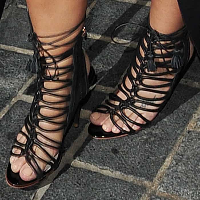 Demi Lovato steps out in striking black Sophia Webster "Lacey" lace-up sandals featuring intricate caged detailing and tassel accents