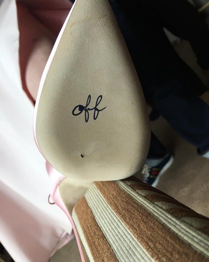 The sole of Elisabeth Moss's custom blush satin Olgana Paris pump features the handwritten word "off," the second half of a hidden feminist message revealed after her Emmy-winning appearance