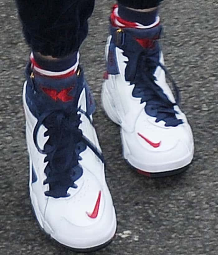 Bella Hadid showcases the distinctive design of the KITH x Nike "Maestro 2" sneakers, featuring their patriotic "USA" colorway, prominent Nike Swoosh, and mid-top silhouette