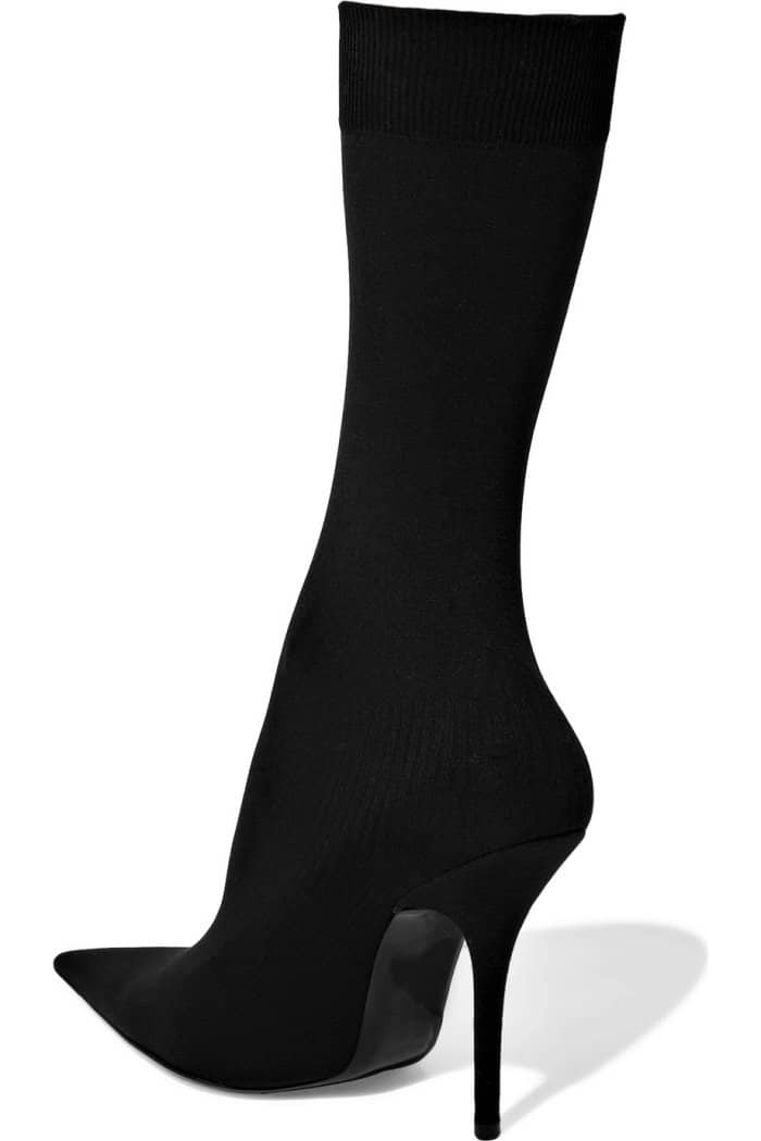 Balenciaga’s black stretch-jersey sock boots feature the brand’s signature knife-sharp pointed toe, a slim stiletto heel, and a ribbed cuff embroidered with the BB logo
