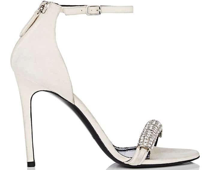 Showcasing a leg-lengthening stiletto heel, this ankle-strap style features a mismatched crystal-embellished strap