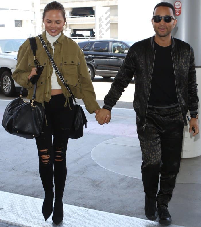 Chrissy Teigen with husband John Legend at the Los Angeles International Airport on August 24, 2017