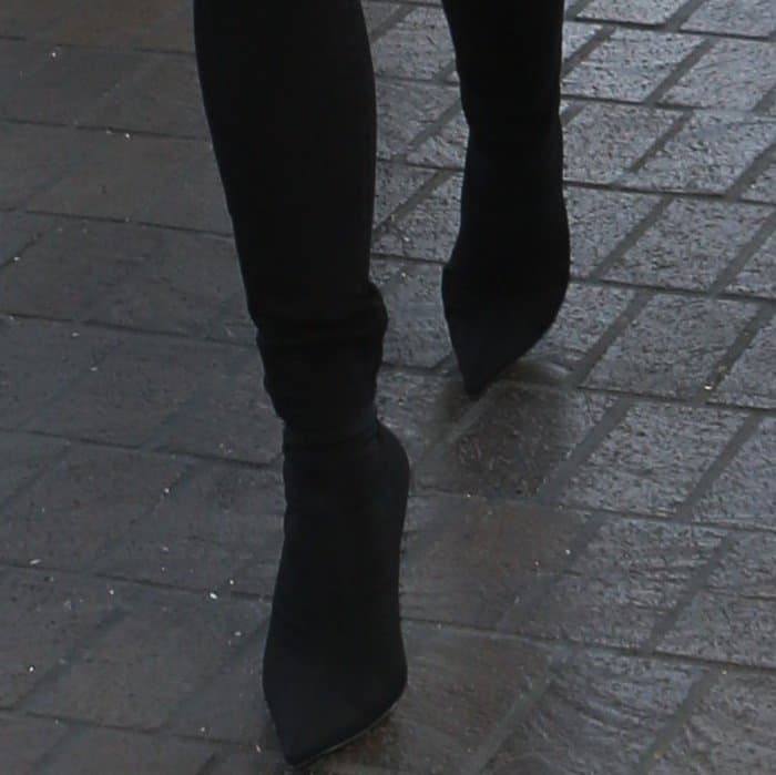 Chrissy Teigen’s Balenciaga sock boots show their exaggerated elongated point, a defining feature of the brand’s knife-toe design