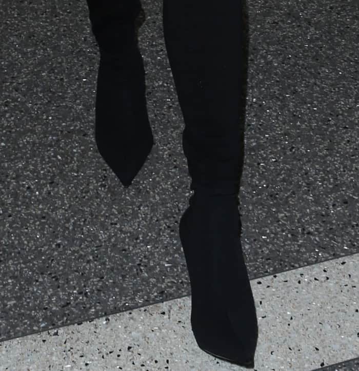 A close-up view of Chrissy Teigen’s Balenciaga knife-toe sock boots reveals their sharply sculpted silhouette and fitted stretch-knit construction