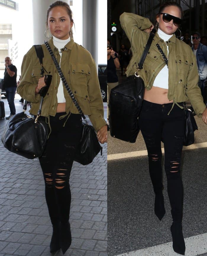 Chrissy Teigen arrives at LAX in an olive Faith Connexion cropped jacket, a white Off-White turtleneck crop top, ripped black skinny jeans, and Balenciaga knife-toe sock boots