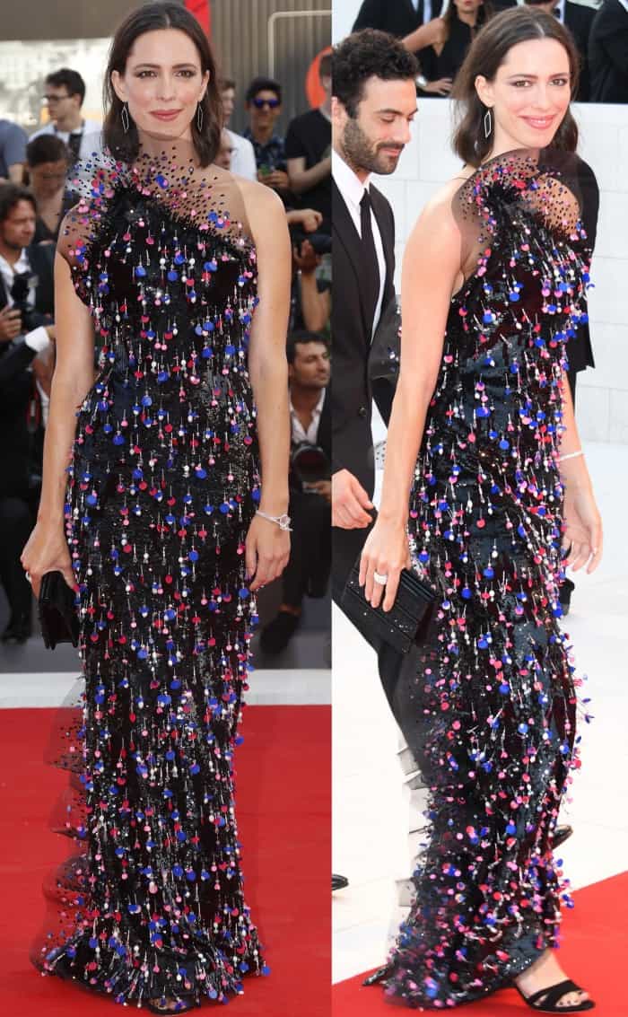 Rebecca Hall turned heads at the “Downsizing” premiere during the 74th Venice Film Festival on August 30, 2017, in a dazzling Armani Privé Fall 2017 one-shoulder gown adorned with sequins and multicolored embellishments, paired with sleek black sandals and a matching clutch