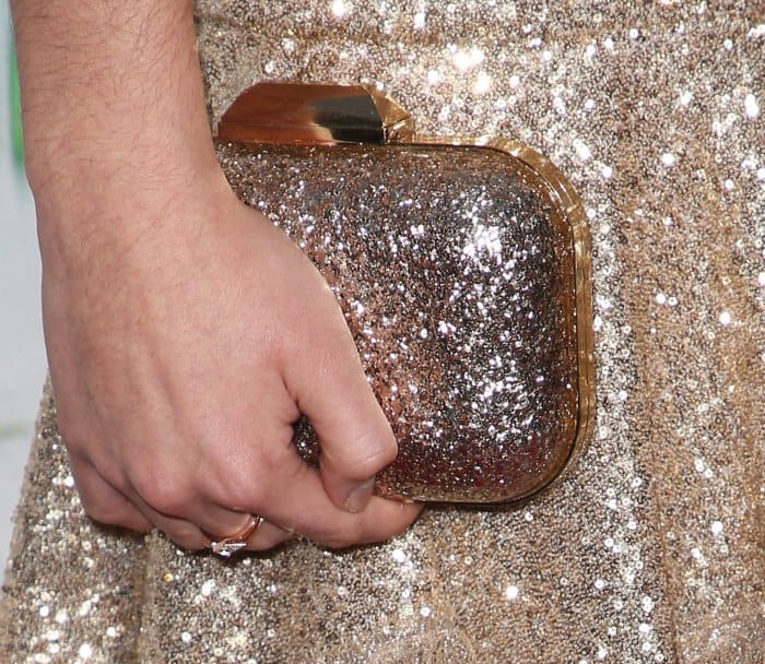 Rowan Blanchard carrying an embellished gold clutch at the "Woodshock" premiere