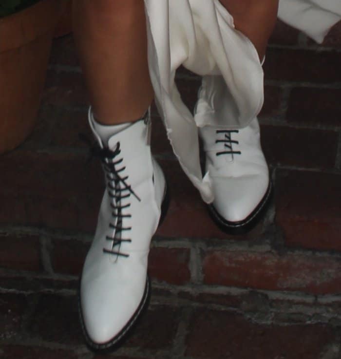 The Row “Fara” lace-up white leather combat boots anchor Sofia’s look, their crisp silhouette adding structure and edge to her soft, tonal ensemble