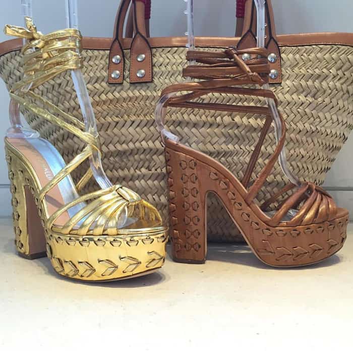 A side-by-side display shows the Alchimia di Ballin “Eryn” platform sandals in gold and brown, emphasizing the brand’s signature woven, sculptural heel detailing