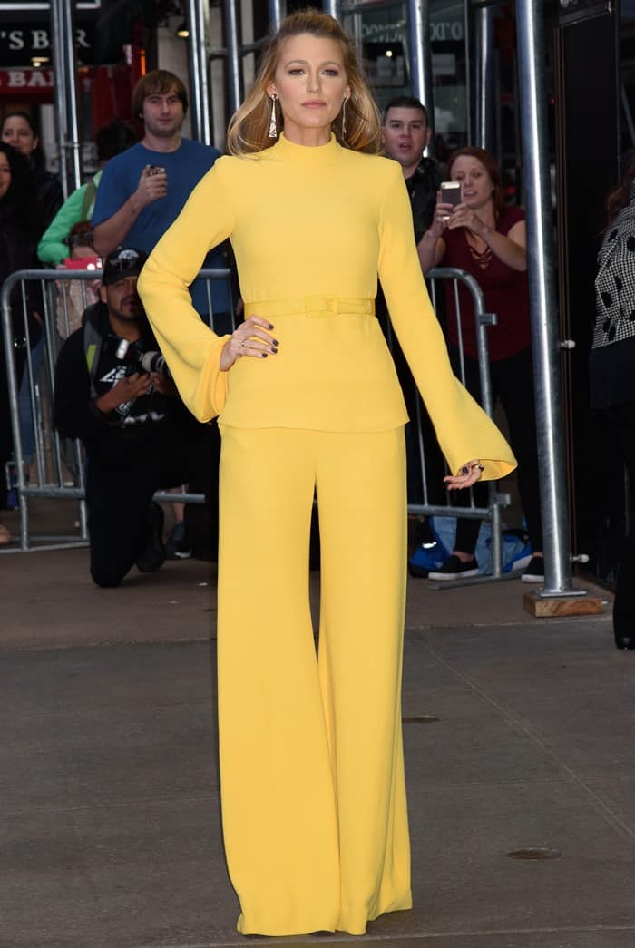 Blake Lively poses curbside in Manhattan, showcasing the clean tailoring and dramatic flared sleeves of her monochromatic Brandon Maxwell Spring 2018 ensemble