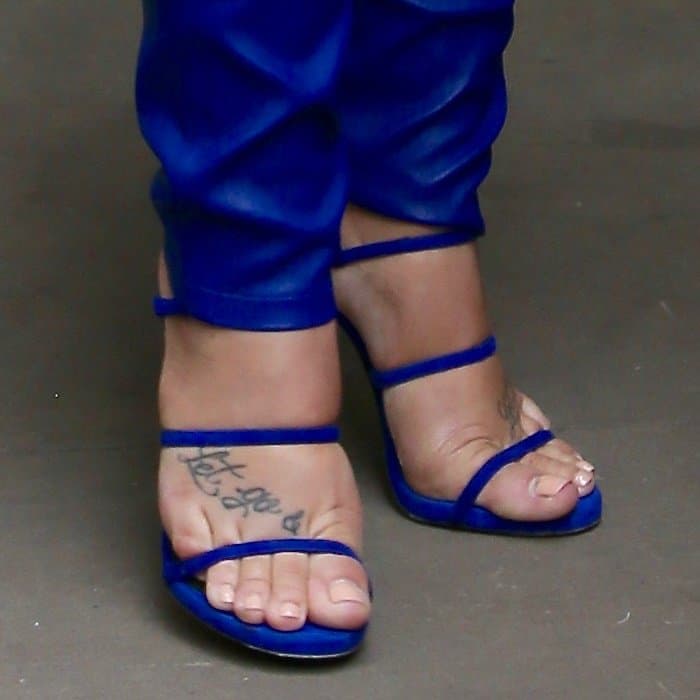 Demi Lovato reveals her “Let Go” foot tattoo in vibrant cobalt blue strappy sandals, the barely-there design and slim ankle straps drawing focus to the script ink and her softly polished natural pedicure