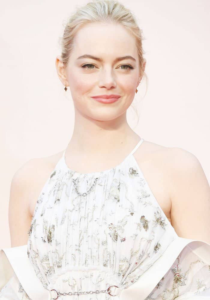 Emma Stone looks radiant with her sleek, pulled-back hairstyle, drawing attention to the intricate silver embroidery and delicate chain detail of her ethereal Louis Vuitton gown at the BFI London Film Festival "Battle Of The Sexes" premiere in London
