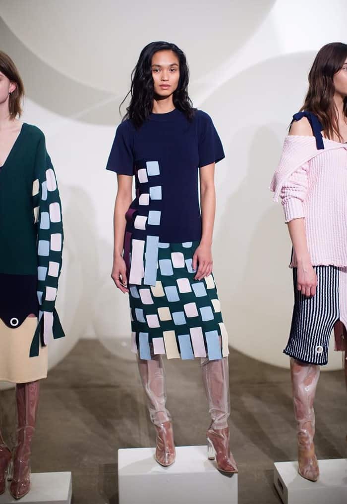 Models showcase foggy, clear thigh-high boots at the PH5 Fall 2017 fashion presentation, highlighting the practical challenges of transparent footwear