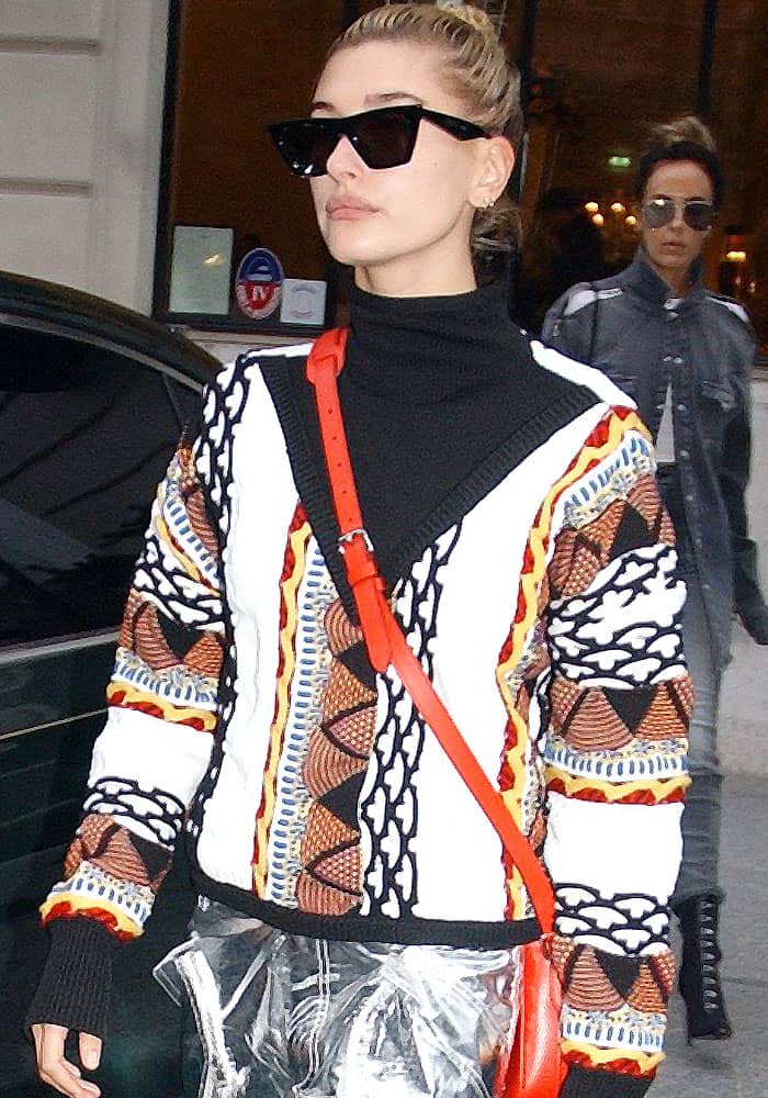 Hailey Baldwin is spotted leaving the Shangri-La Hotel in Paris during Fashion Week on September 28, 2017, turning heads in a bold, print-heavy street style look