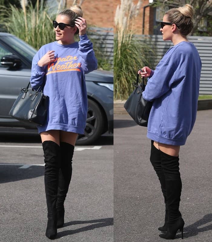Georgia Kousoulou effortlessly combines cozy and chic in an oversized 'Sweater Weather' sweatshirt paired with thigh-high black boots and a classic Prada handbag in Woodford