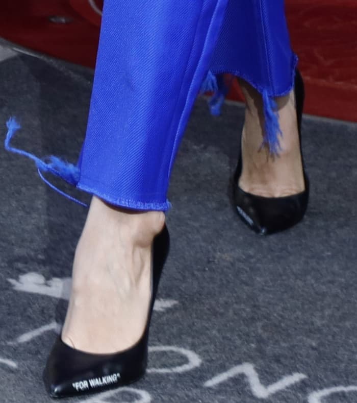 Bella Hadid wearing Off-White "For Walking" black leather pumps while leaving her hotel in Paris