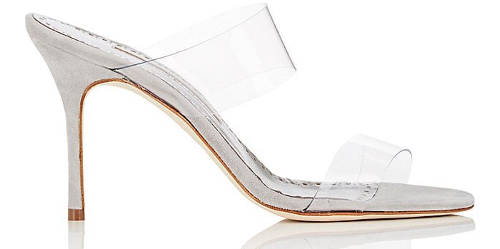 The Manolo Blahnik “Scolto” mules combined grey suede with transparent PVC straps, capturing the barely-there “naked shoe” trend that dominated late-2010s celebrity fashion