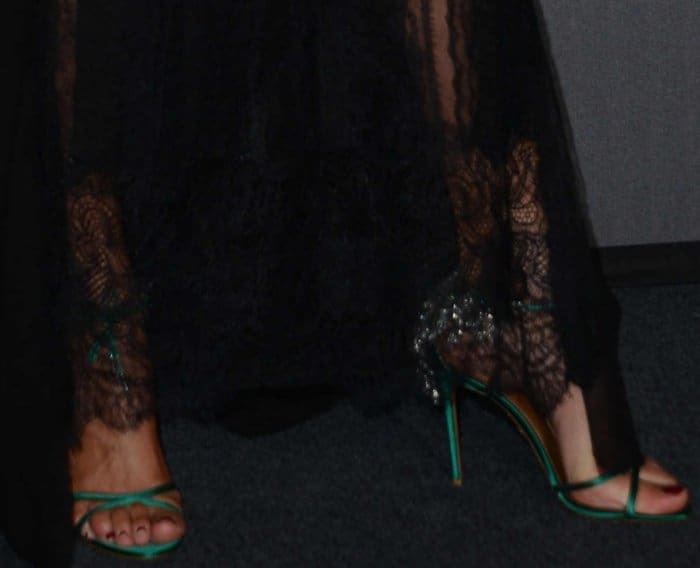 Nieves Alvarez adds a pop of color to her black ensemble with green embellished Aquazzura sandals