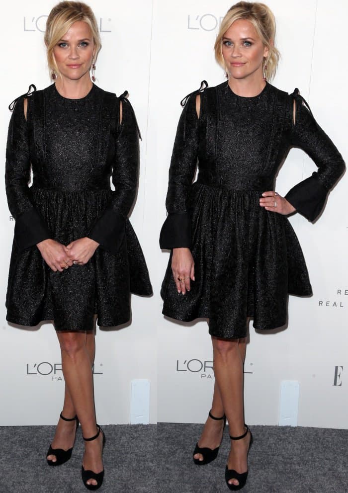 Reese Witherspoon opted for a chic black dress with textured fabric and bow-tied shoulder details, pairing it with classic black peep-toe heels for an elegant finish
