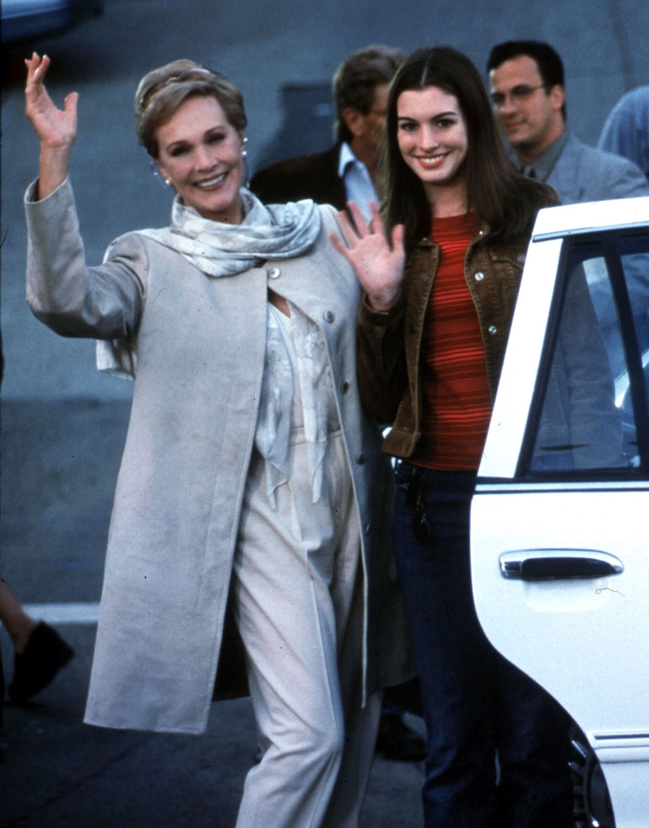 Promotional still from The Princess Diaries featuring Julie Andrews as Queen Clarisse Renaldi in an elegant cream ensemble and Anne Hathaway as Mia Thermopolis in a casual striped top and leather jacket, capturing their characters' contrasting worlds
