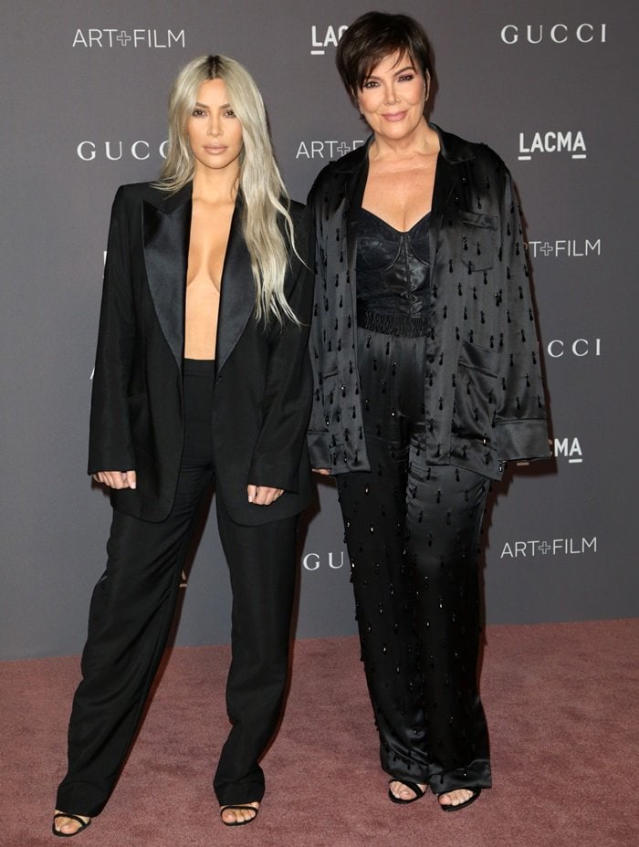 Kim Kardashian pairs her vintage Tom Ford tuxedo with sleek black strappy sandals, while Kris Jenner complements her satin silk jacket and pants with elegant black open-toe heels at the 2017 LACMA Art + Film Gala
