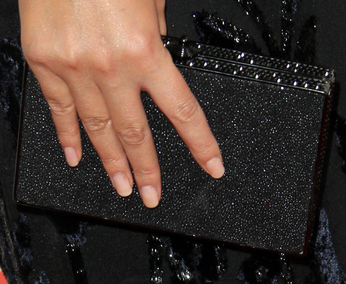 Chrissy Teigen added extra sparkle to her monochromatic evening look with a structured glitter clutch finished in a subtle crystal texture