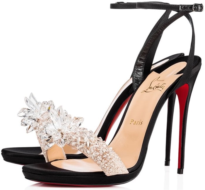 Christian Louboutin’s “Crystal Queen” Sandals — a bold mix of black crepe satin, sparkling crystal appliqué, and the brand’s iconic red lacquered sole
