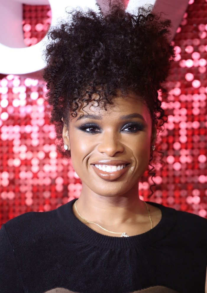 Jennifer Hudson showcases a glamorous and playful look with her high-volume, textured curly updo, beautifully framing her face