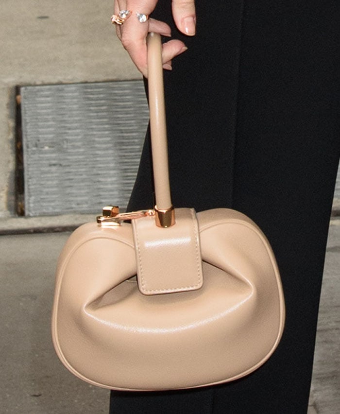 A sculptural Gabriela Hearst "Demi" bag in nude leather introduced a warm contrast to Kate Bosworth's sleek all-black ensemble