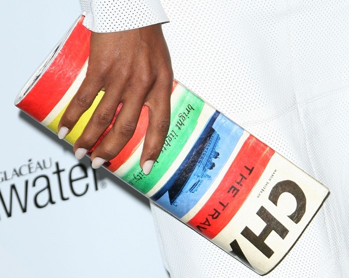 Kerry toting a Kate Spade New York 'Make Headlines Travel Edition Magazine' clutch