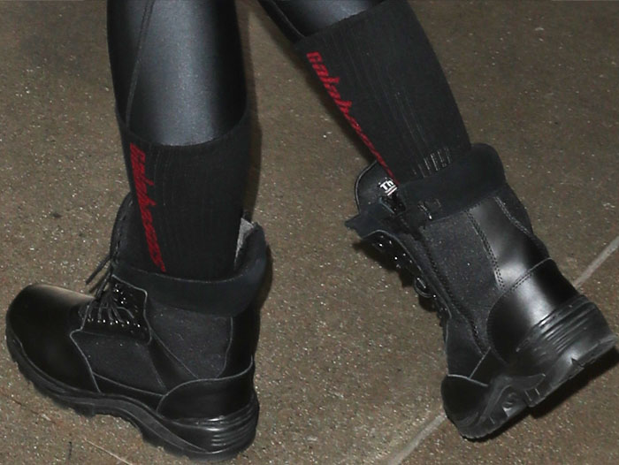 A subtle nod to Kanye West's label, Khloé Kardashian pairs her combat boots with Yeezy 'Calabasas' socks, showcasing how branded socks can elevate a casual footwear look