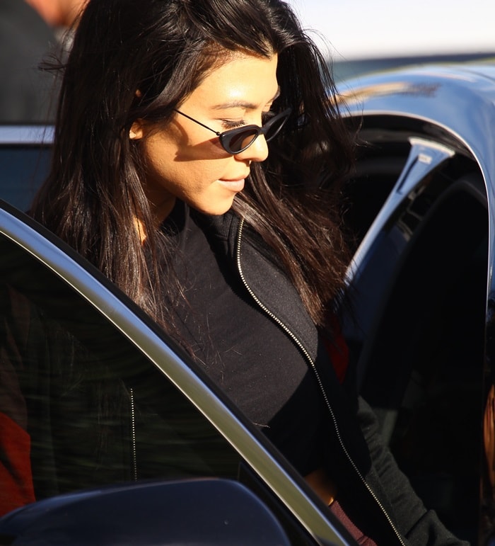 Kourtney Kardashian is spotted stepping out of her car in West Hollywood, effortlessly chic in sleek sunglasses and a zip-up jacket