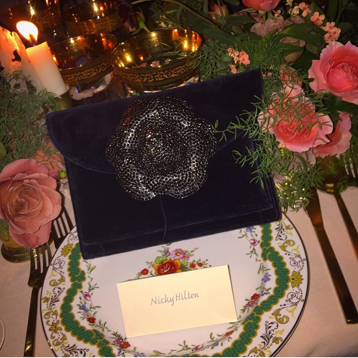 Nicky uploads a photo of her purse next to her name card