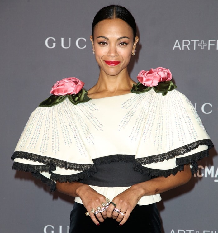 The actress poses confidently in her crystal-studded Gucci capelet, letting the dramatic rose appliqués take center stage