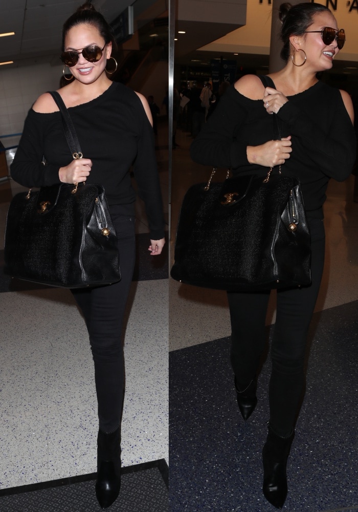 Chrissy Teigen sharpens her all-black airport look with Saint Laurent “Niki” boots, pairing the pointed-toe silhouette with an RTA Willow sweatshirt, J Brand skinny jeans, and a classic Chanel Supermodel XL bag for effortless off-duty polish