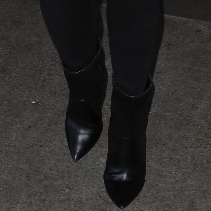 Chrissy Teigen pairs her jeans with sleek mixed-leather mid-calf boots, featuring sharp pointed toes that add polish to her off-duty look