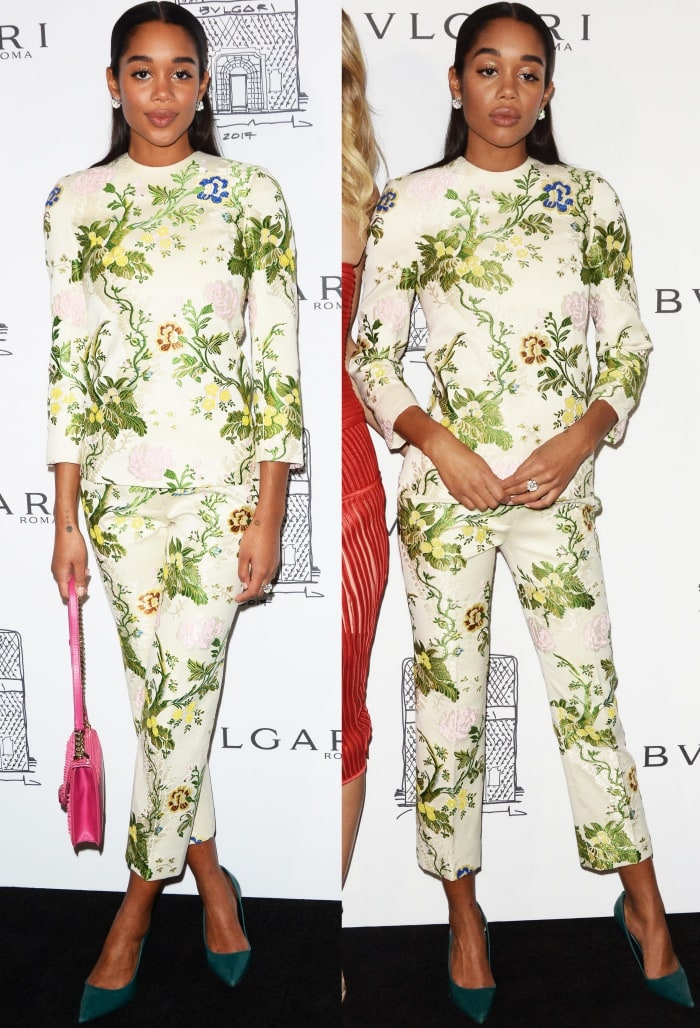 Laura Harrier embraces feminine charm in a floral Calvin Klein by Appointment ensemble, finishing the bold print with a statement pink handbag and sleek green suede pumps