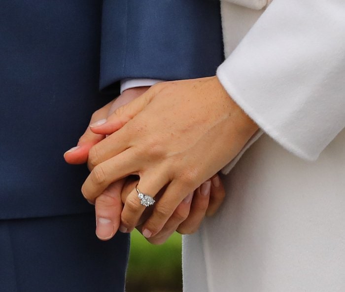 Meghan Markle's engagement ring, designed by Prince Harry and crafted by Cleave Company, features a cushion-cut diamond from Botswana flanked by two stones from Princess Diana’s collection—an elegant, deeply personal trilogy