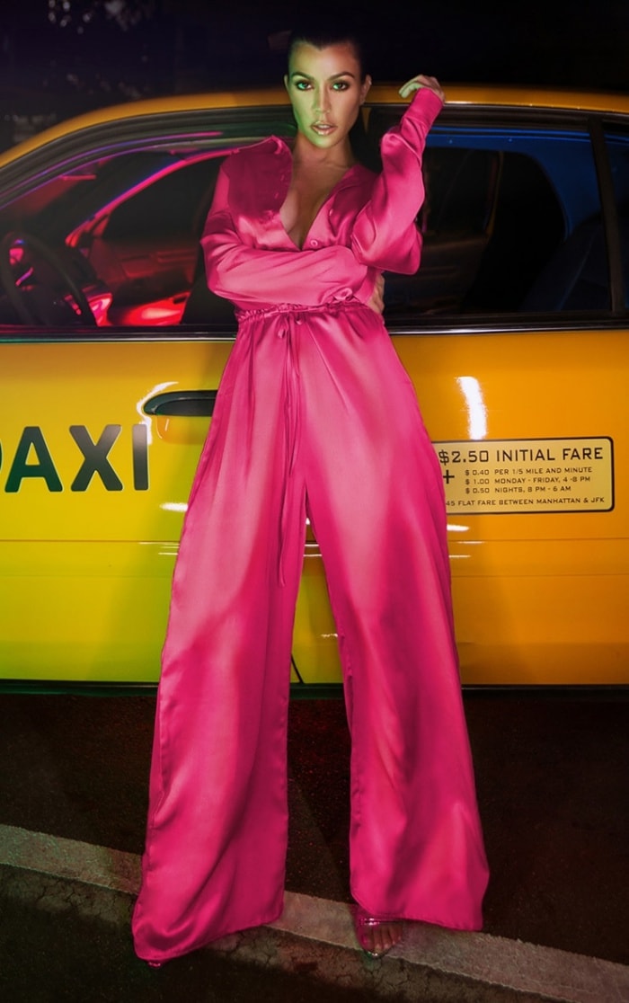 Flowing satin in vivid pink takes center stage, finished with barely-there heels that let the color and movement command attention