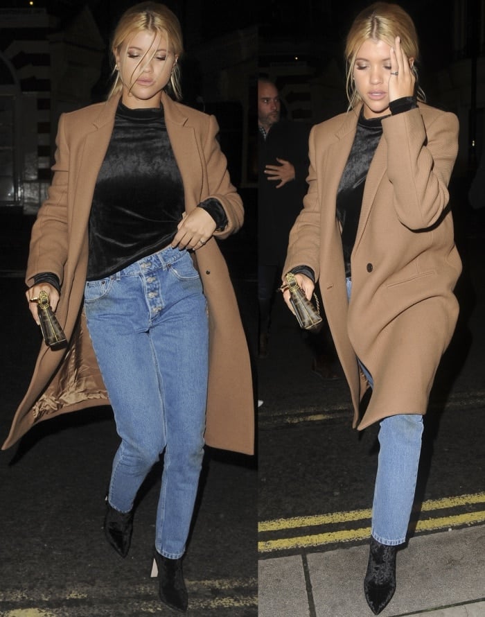 Sofia Richie wearing a Theory coat and turtleneck top, Balenciaga "Tube" jeans, and black velvet pointy-toe boots
