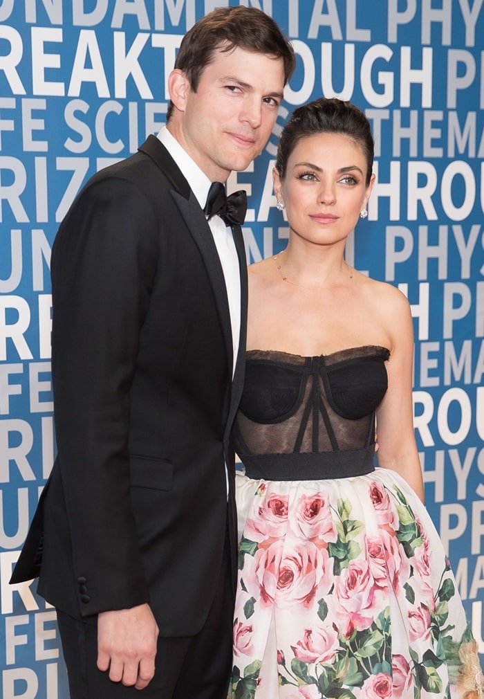 Joined by Ashton Kutcher, Mila Kunis donned a Dolce Gabbana ensemble that showcased a striking contrast between sultriness and feminine charm