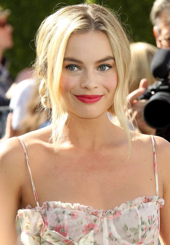 Margot Robbie was radiant with a bold berry lip and face-framing blonde waves